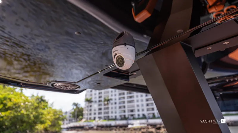 Slide: The Image of 2025 Skipper-BSK 38 yacht with Garmin camera, docked near waterfront buildings. - 45