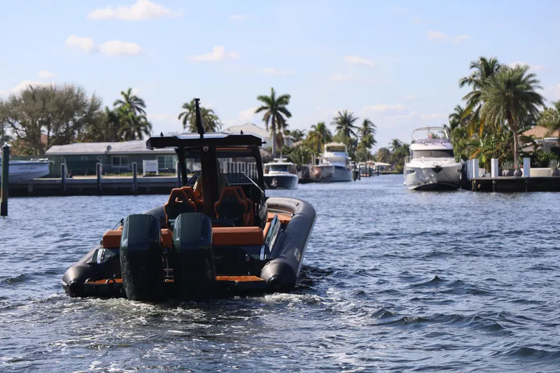 Slide: The Image of 2025 Skipper-BSK 38 boat cruising through a scenic waterway with palm trees. - 9