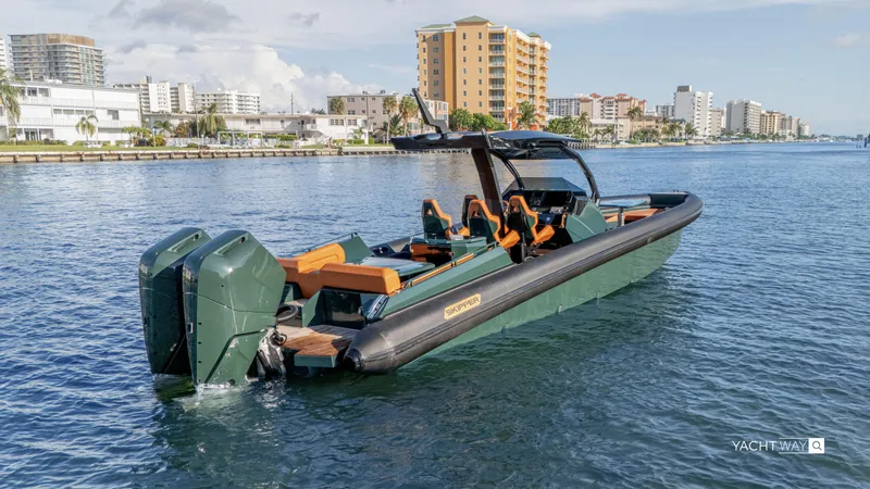 Slide: The Image of Skipper-BSK 38 boat, 2025 model, on water with cityscape background. - 29