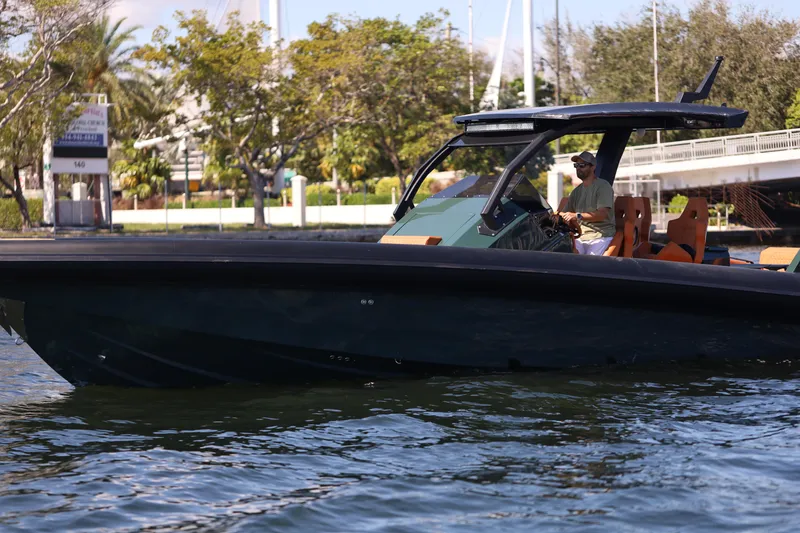 Slide: The Image of 2025 Skipper-BSK 38 boat cruising on a calm waterway, surrounded by lush greenery. - 16