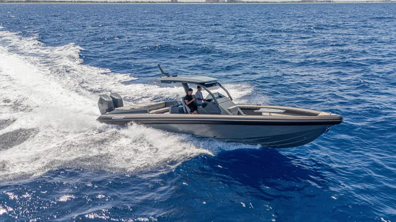 Slide: The Image of 2025 Skipper-BSK 38 boat cruising on open blue sea, creating a dynamic wake. - 14