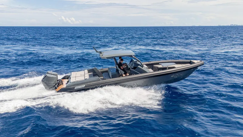 Slide: The Image of 2025 Skipper-BSK 38 boat cruising on open ocean waters. - 17