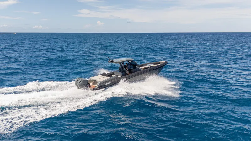 Slide: The Image of 2025 Skipper-BSK 38 boat cruising on open ocean under clear sky. - 6