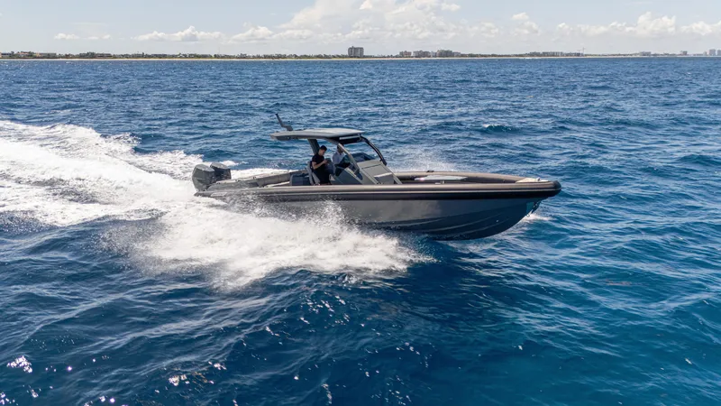 Slide: The Image of 2025 Skipper-BSK 38 boat cruising on open blue ocean waters. - 7