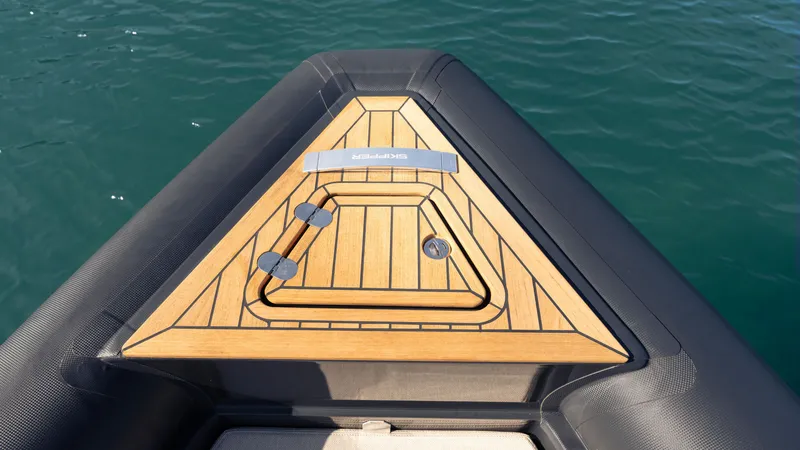 Slide: The Image of Bow of Skipper-BSK 38 boat, 2025 model, featuring sleek wooden deck design. - 26