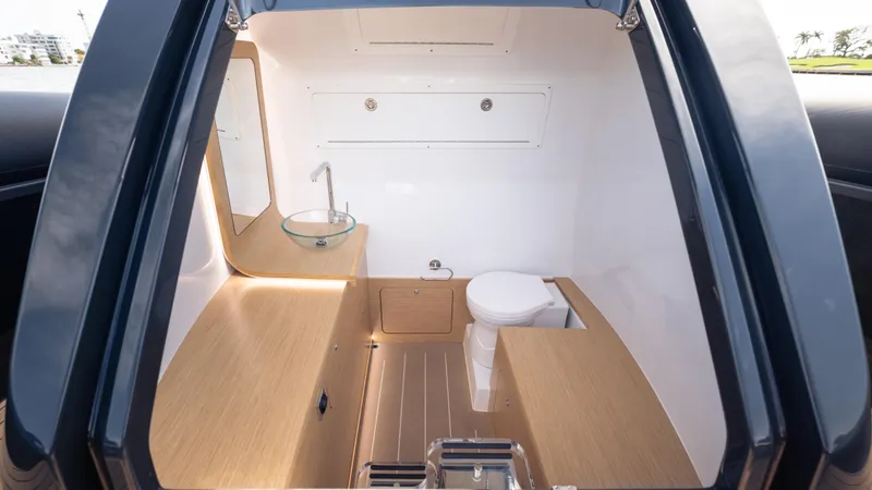 Slide: The Image of Modern Skipper 38 boat interior with wooden finish and compact bathroom, 2025 model. - 22