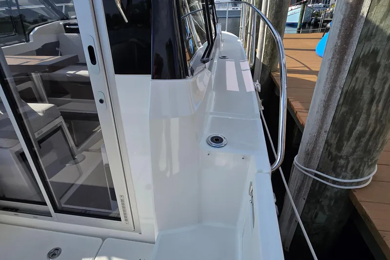 Slide: The Image of 2023 Jeanneau NC Sport 795 Series 2 boat docked, showcasing sleek design and spacious interior. - 10