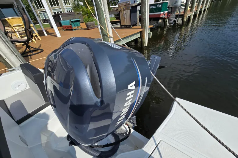 Slide: The Image of 2023 Jeanneau NC Sport 795 Series 2 with Yamaha outboard motor docked by waterfront. - 13