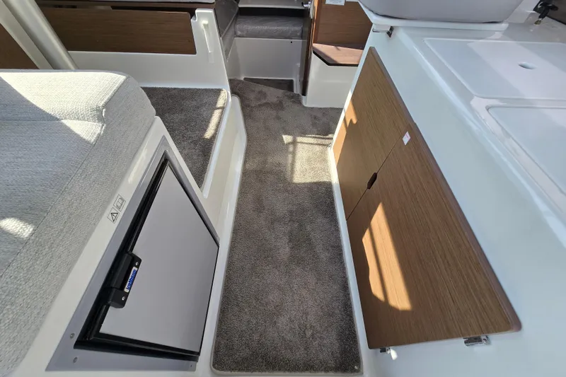 Slide: The Image of Interior of 2023 Jeanneau NC Sport 795 Series 2, featuring compact kitchen and seating area. - 25