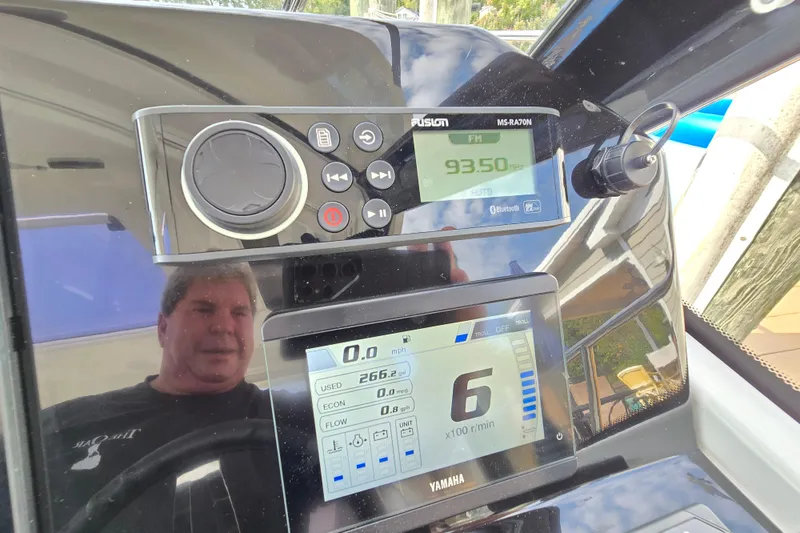 Slide: The Image of Dashboard of 2023 Jeanneau NC Sport 795 Series 2 with radio and Yamaha display. - 43