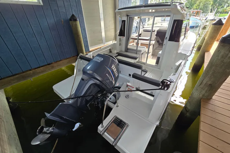 Slide: The Image of 2023 Jeanneau NC 795 Series 2 boat with Yamaha outboard motor docked. - 57