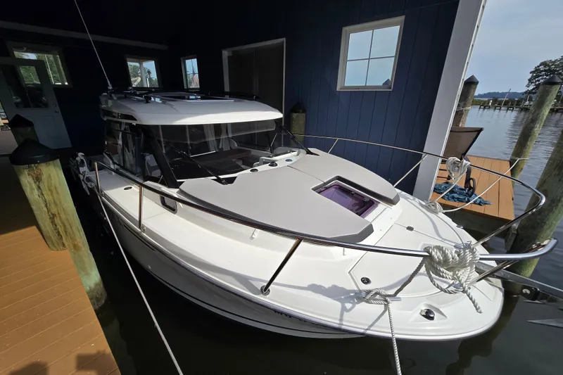 Slide: The Image of 2023 Jeanneau NC 795 Series 2 boat docked in a marina. - 58