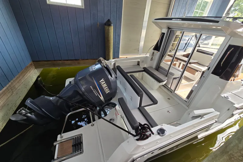 Slide: The Image of 2023 Jeanneau NC 795 Series 2 boat with Yamaha outboard motor in docked position. - 60