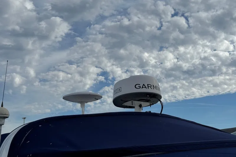 Slide: The Image of Radar equipment on a 2000 Sea Ray 410 Sundancer against a cloudy sky. - 11