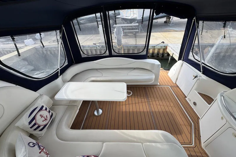 Slide: The Image of Luxurious interior of 2000 Sea Ray 410 Sundancer yacht with elegant seating and table. - 12