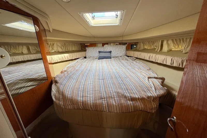 Slide: The Image of Luxurious cabin interior of 2000 Sea Ray 410 Sundancer yacht with cozy bed and skylight. - 18