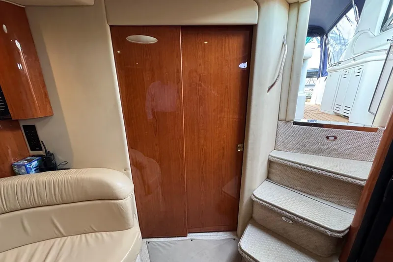 Slide: The Image of Interior of 2000 Sea Ray 410 Sundancer with wooden door and carpeted stairs. - 21