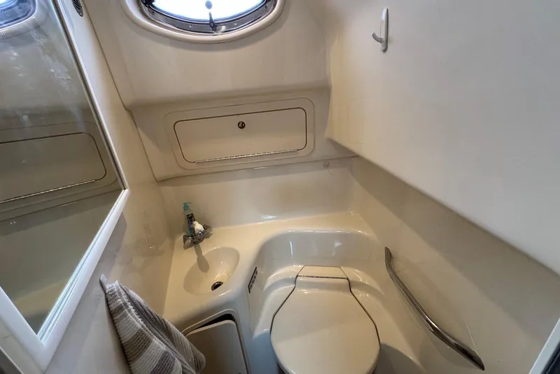 Slide: The Image of Compact bathroom in 2000 Sea Ray 410 Sundancer yacht with sink and toilet. - 22