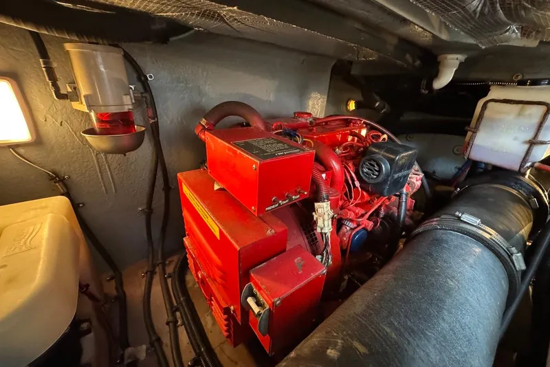 Slide: The Image of Engine room of 2000 Sea Ray 410 Sundancer with red machinery and components. - 24