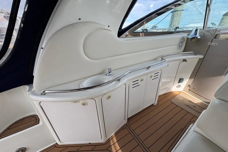 Slide: The Image of Interior view of 2000 Sea Ray 410 Sundancer yacht with sink and storage cabinets. - 9
