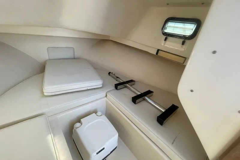 Slide: The Image of Interior cabin of 2001 Parker 2520 Deep Vee Sport Cabin boat, featuring seating and storage. - 2
