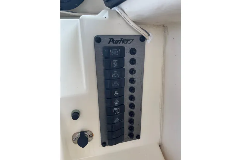 Slide: The Image of Control panel of a 2001 Parker 2520 Sport Cabin boat with labeled switches. - 6
