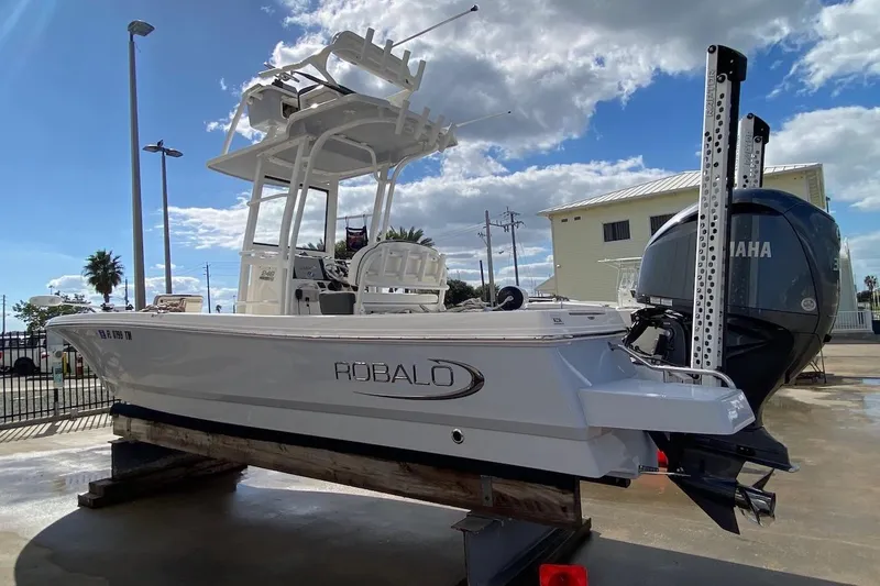 The Image of 2023 Robalo 246 Cayman SD boat with Yamaha engine, displayed outdoors on a sunny day. - 1