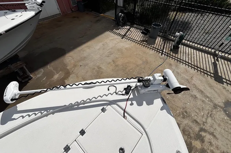 Slide: The Image of 2023 Robalo 246 Cayman SD boat with trolling motor on deck. - 13