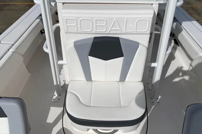 Slide: The Image of 2023 Robalo 246 Cayman SD boat seat with embossed logo, white and gray design. - 23