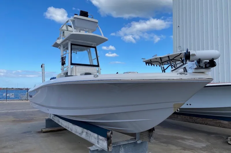 Slide: The Image of 2023 Robalo 246 Cayman SD boat on display, clear sky background. - 3