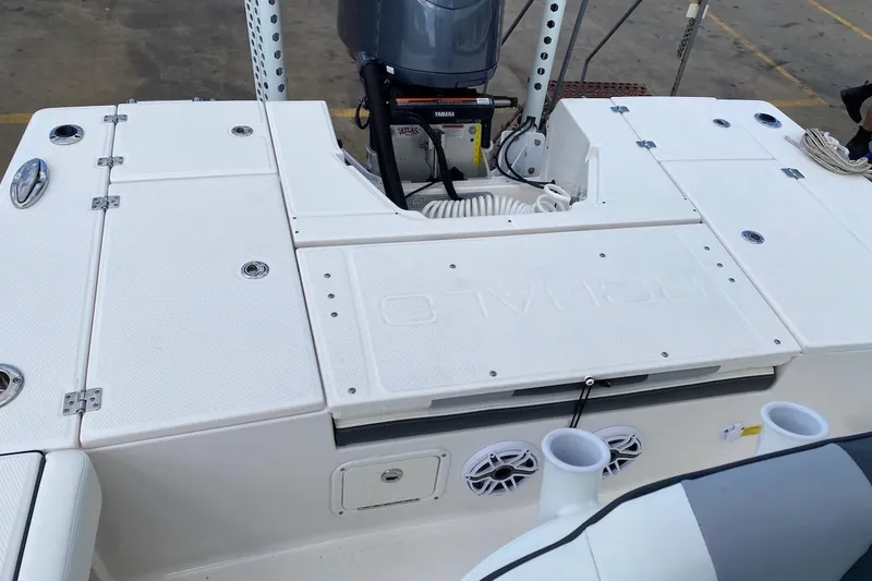 Slide: The Image of 2023 Robalo 246 Cayman SD boat deck with storage compartments and motor. - 32