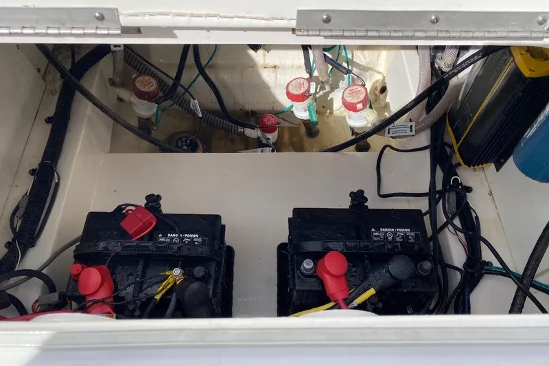 Slide: The Image of 2023 Robalo 246 Cayman SD boat battery compartment with wiring and components. - 34