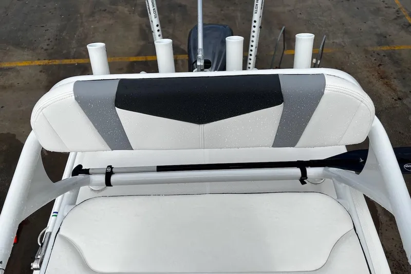 Slide: The Image of 2023 Robalo 246 Cayman SD boat seat with rod holders, wet from rain. - 46