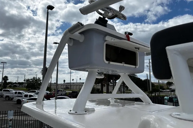 Slide: The Image of 2023 Robalo 246 Cayman SD boat console against cloudy sky backdrop. - 49