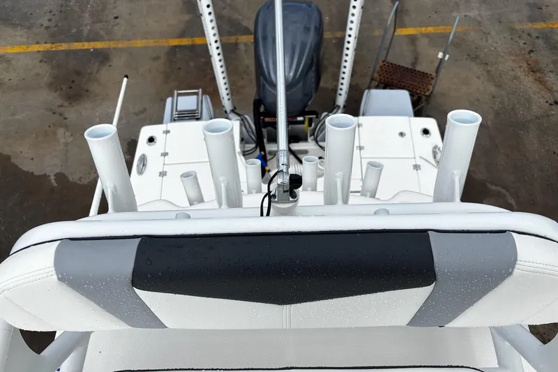 Slide: The Image of 2023 Robalo 246 Cayman SD boat deck with rod holders and engine view. - 50