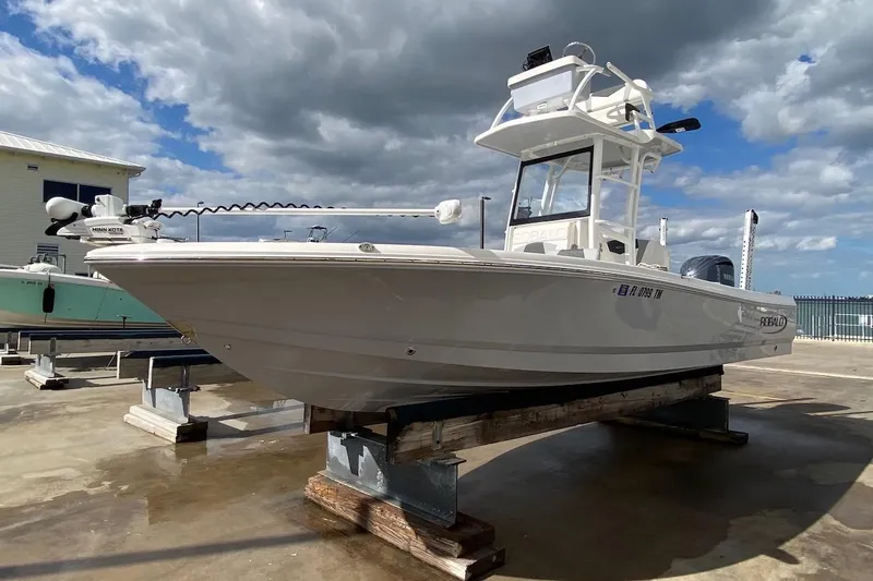 Slide: The Image of 2023 Robalo 246 Cayman SD boat on display under cloudy sky. - 54