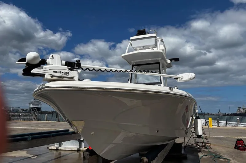 Slide: The Image of 2023 Robalo 246 Cayman SD boat docked under cloudy sky. - 55