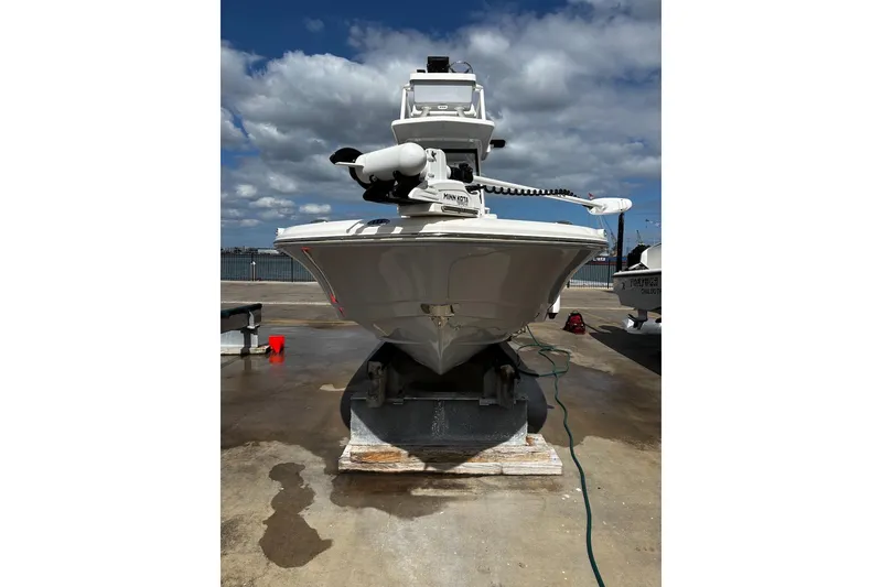 Slide: The Image of 2023 Robalo 246 Cayman SD boat on dock under cloudy sky. - 6