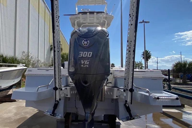 Slide: The Image of 2023 Robalo 246 Cayman SD boat with Yamaha 300 V6 engine, docked outdoors. - 7