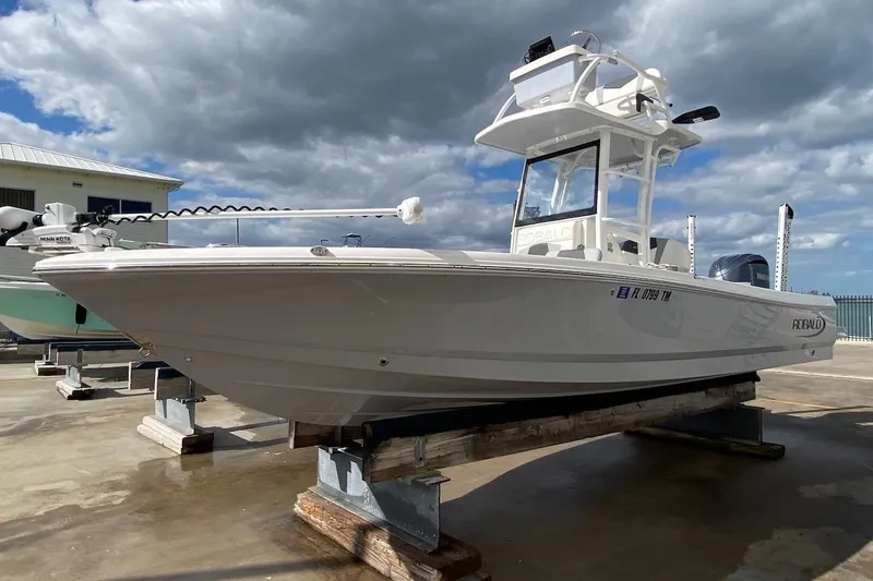 Slide: The Image of 2023 Robalo 246 Cayman SD boat on display under cloudy sky. - 8