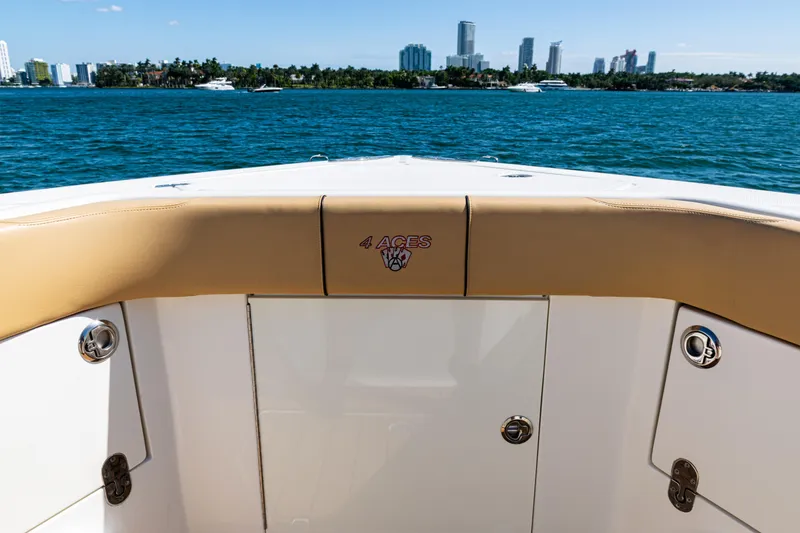 Slide: The Image of 2016 SeaVee 430 boat deck with "4 Aces" logo, city skyline in background. - 10