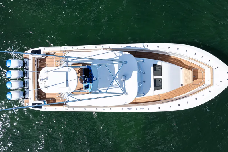 Slide: The Image of Aerial view of 2016 SeaVee 430 boat with four engines on green water. - 100