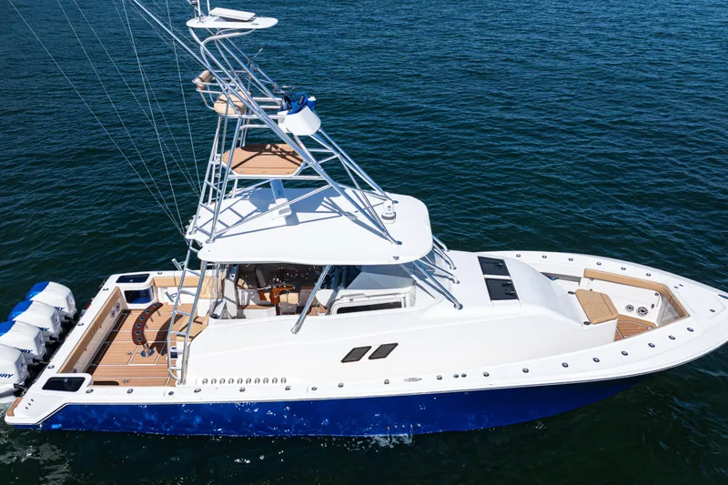 Slide: The Image of 2016 SeaVee 430 boat with blue hull and multiple outboard engines on open water. - 104