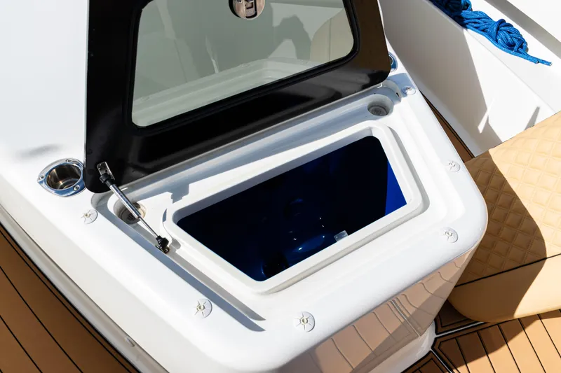 Slide: The Image of Open storage compartment on 2016 SeaVee 430 boat with cushioned seating and blue rope. - 13