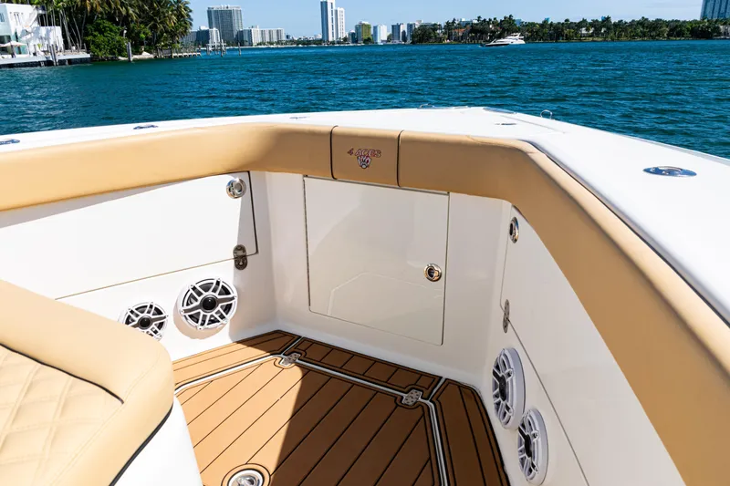 Slide: The Image of 2016 SeaVee 430 boat interior with tan seating, speakers, and ocean view. - 14
