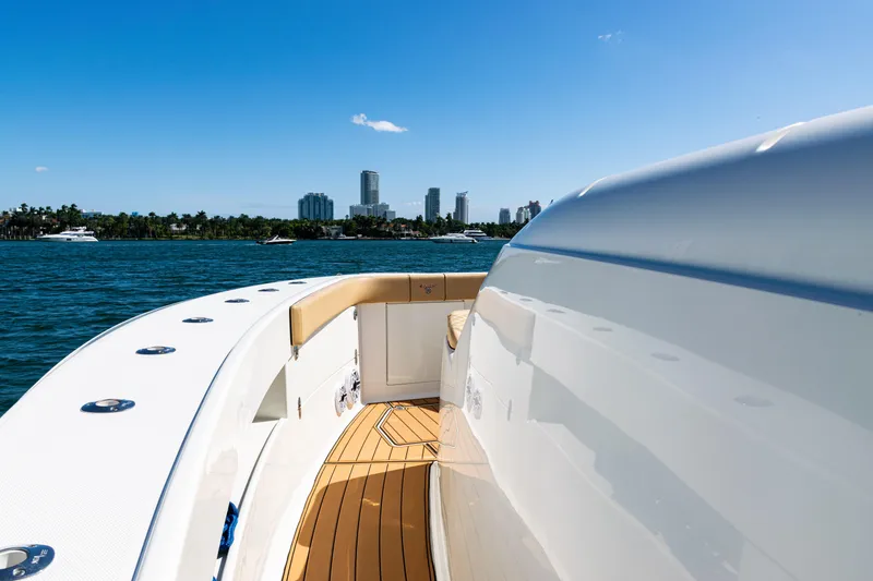 Slide: The Image of 2016 SeaVee 430 boat on water with city skyline in background. - 16