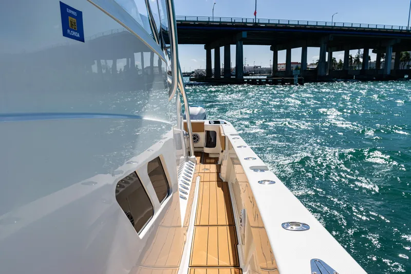 Slide: The Image of 2016 SeaVee 430 boat cruising under a bridge on sparkling blue water. - 20
