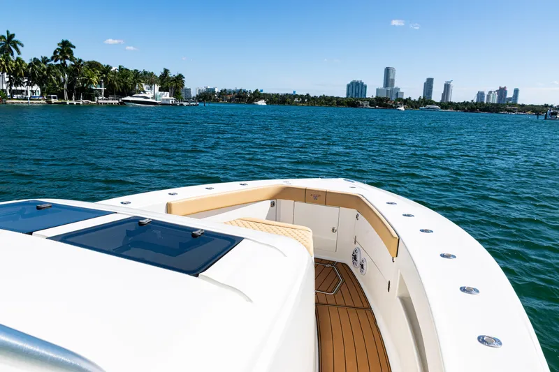 Slide: The Image of 2016 SeaVee 430 boat on blue water with city skyline and palm trees. - 22