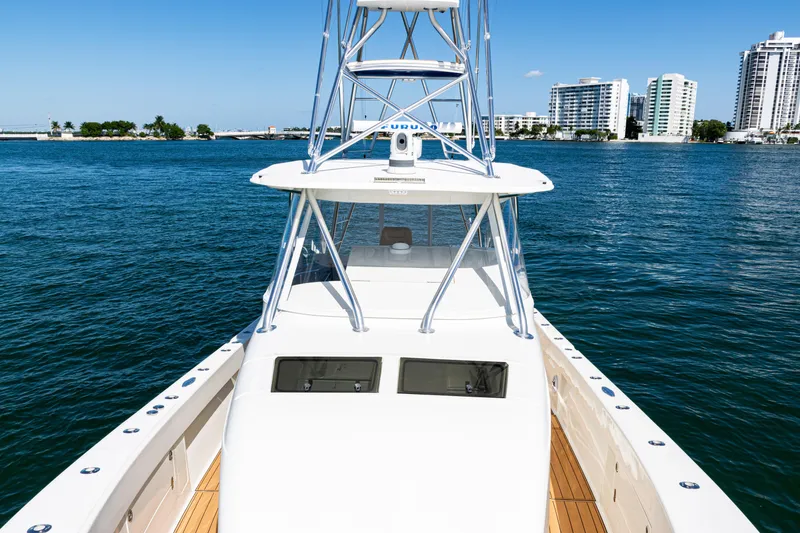 Slide: The Image of 2016 SeaVee 430 boat on water with city skyline in background. - 25