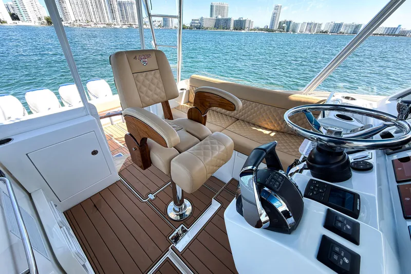 Slide: The Image of Luxurious 2016 SeaVee 430 boat interior with helm, leather seating, and ocean view. - 28